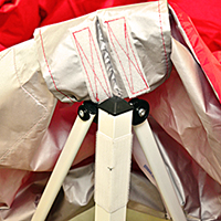 Step 3: Drape the canopy over the frame. At each corner, secure the canopy using the hook-and-loop tabs.