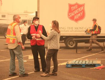 Salvation Army Captain Michael O'Brien (center) directing resources at the evacuation center.