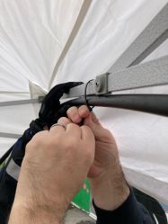 Zip tying hose to inside of canopy.